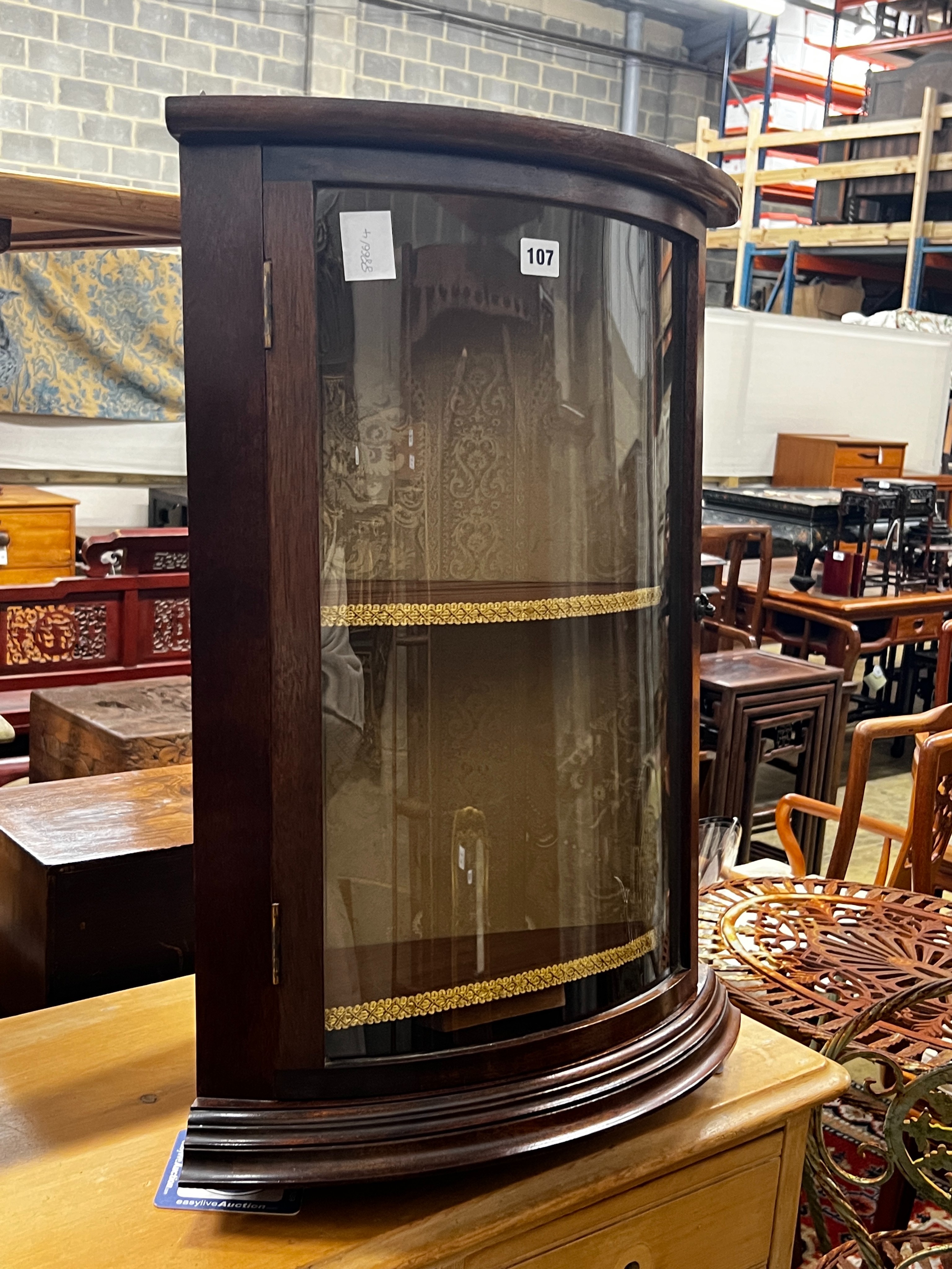 A reproduction George III style glazed mahogany bowfront hanging corner cupboard, width 49cm, depth 34cm, height 66cm